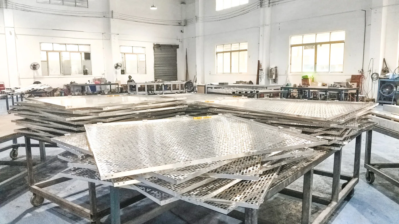 Aluminum Curtain Wall Cost Guide 2026: Price Per m², Factors & Budget Tips Likton perforated aluminum curtain wall panels stacked in production workshop ready for quality inspection