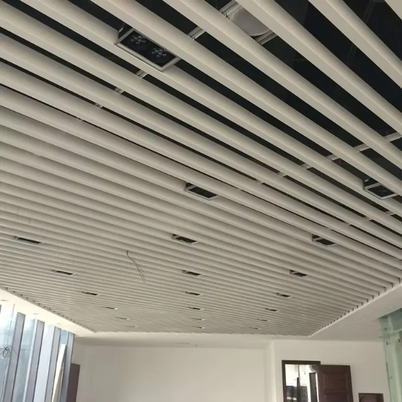 Aluminum Baffle Ceiling Cost: How Spacing and Accessories Change the Quote Metal baffle ceiling with lighting and service openings during interior construction