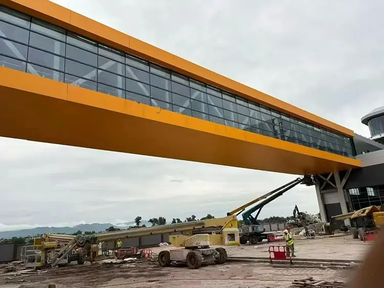 Commercial Aluminum Soffit Panels: Canopy Buying Guide Orange underside and edge cladding on an elevated enclosed link during construction