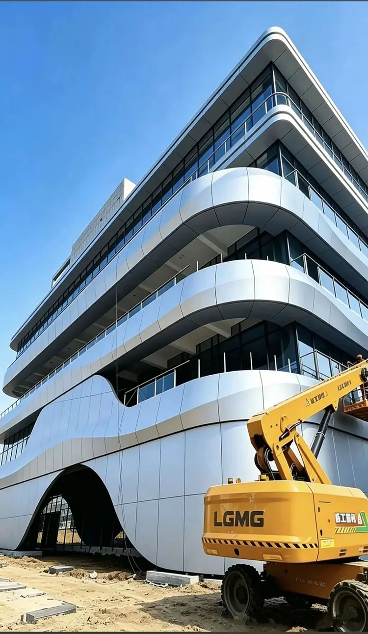 Curved aluminum cladding panels on a commercial facade under construction