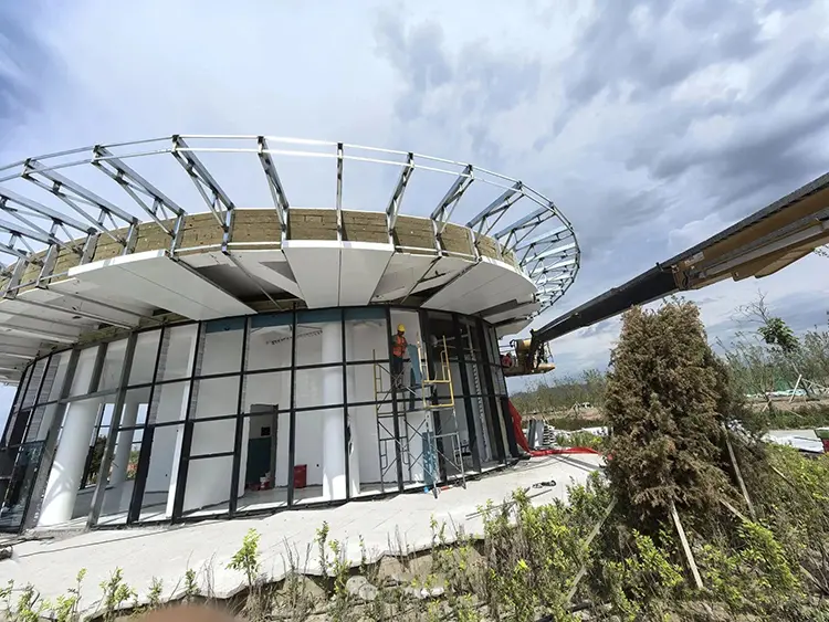 Curved Aluminum Cladding Panels: Radius, Joints and Buying Checks Segmented curved aluminum canopy panels and supporting frame during installation