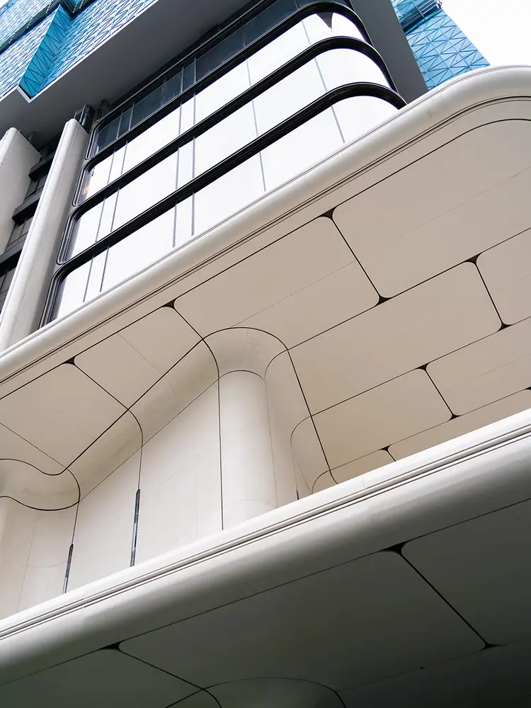 Curved Aluminum Cladding Panels: Radius, Joints and Buying Checks Close view of curved aluminum cladding joints at a facade and soffit transition