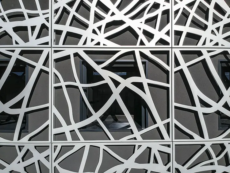 Free-form white aluminum screen panels with a continuous irregular pattern