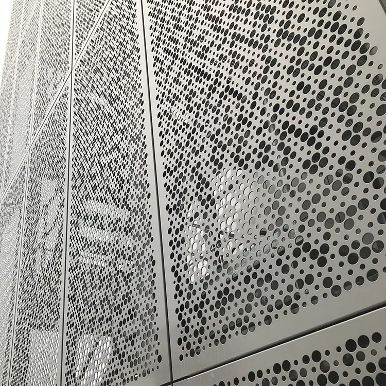 Laser Cutting vs Punching Aluminum Panels: What to Choose White aluminum panels with repeated circular openings arranged as a graded pattern