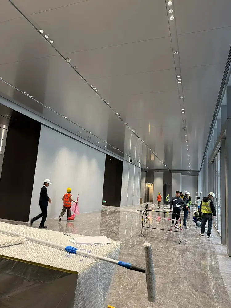 Custom Aluminum Column Covers: Sizes, Joints and Buying Guide Metal wall and ceiling cladding meeting in an interior space during installation